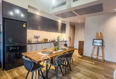 Modern kitchen with sleek black appliances and stylish wooden dining table