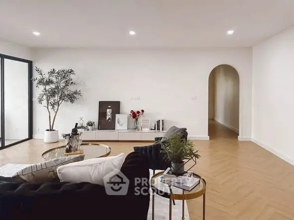 Spacious modern living room with elegant decor and natural light.