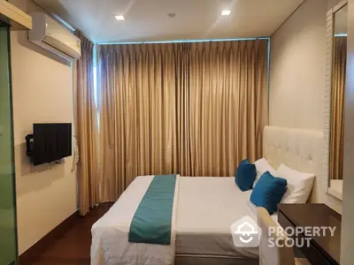 Luxurious bedroom with elegant curtains and modern decor in upscale apartment.