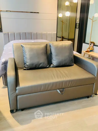 Modern bedroom with stylish sofa bed and elegant lighting, perfect for urban living.