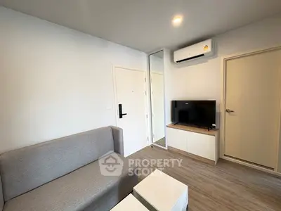 Modern living room with sleek furniture and air conditioning, perfect for comfortable living.