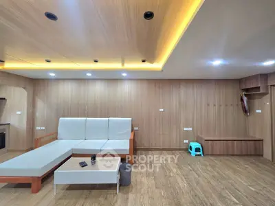 Spacious modern living room with wooden accents and ambient lighting