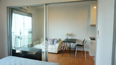 Modern apartment with open layout, featuring a cozy living area and dining space, perfect for urban living.