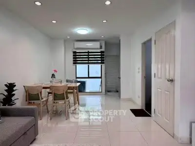 Modern living room with dining area, featuring sleek furniture and bright lighting, perfect for urban living.