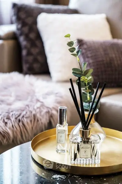 Elegant living room with plush cushions and stylish decor on a marble table.