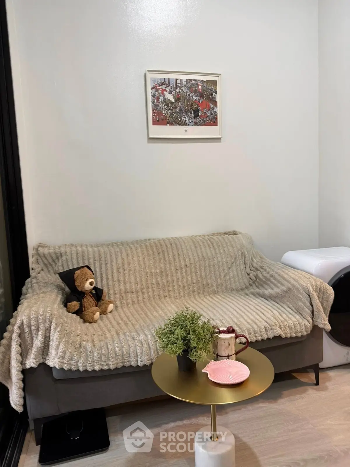 Cozy living room with plush sofa, teddy bear, and modern decor