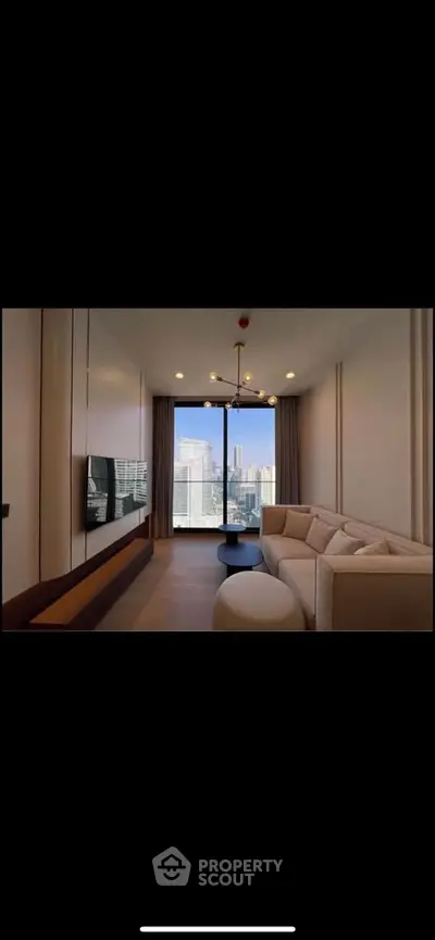 Modern living room with city view, stylish furniture, and elegant lighting in a high-rise apartment.