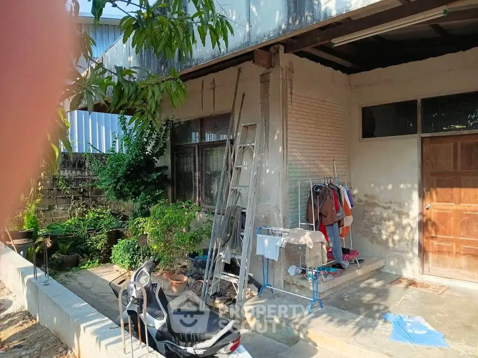 Charming rustic exterior with lush greenery and cozy outdoor space, perfect for relaxation and gardening enthusiasts.