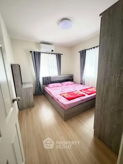 Cozy bedroom with modern furnishings and natural light, featuring a comfortable bed and stylish decor.