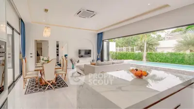 Luxurious open-plan living room with pool view and elegant dining area.