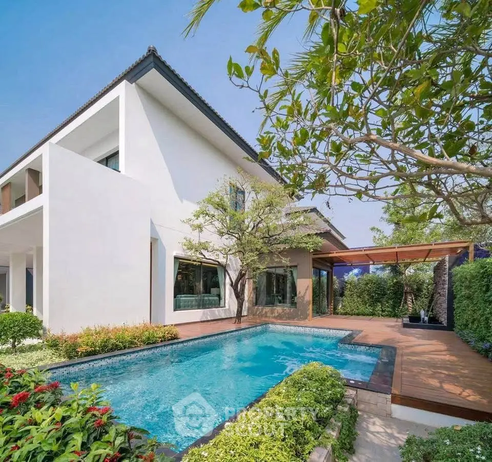 Luxurious modern home with private pool and lush garden, perfect for serene living.