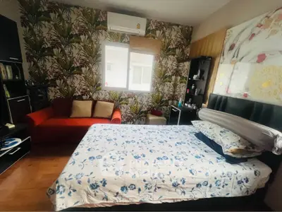 Cozy bedroom with floral wallpaper and modern furnishings