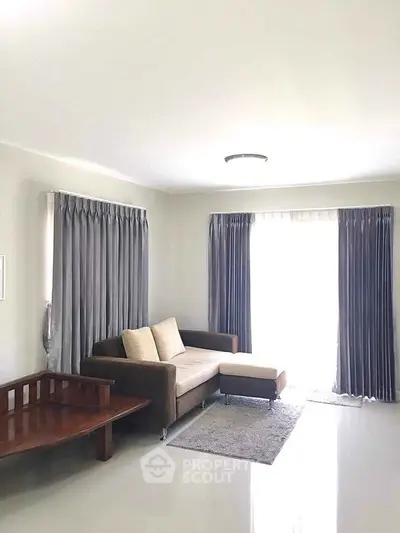 Bright living room with modern sofa and elegant curtains