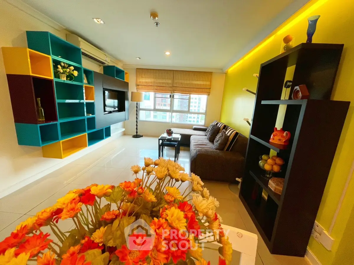 Vibrant living room with colorful shelving and cozy seating area, perfect for modern living.