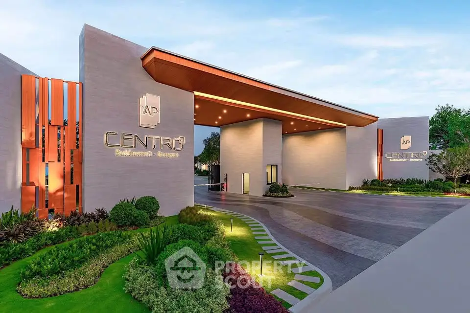 Modern apartment entrance with sleek design and lush landscaping at Centro Apartments.