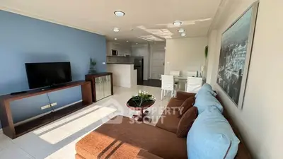 Spacious living room with modern decor and open kitchen layout