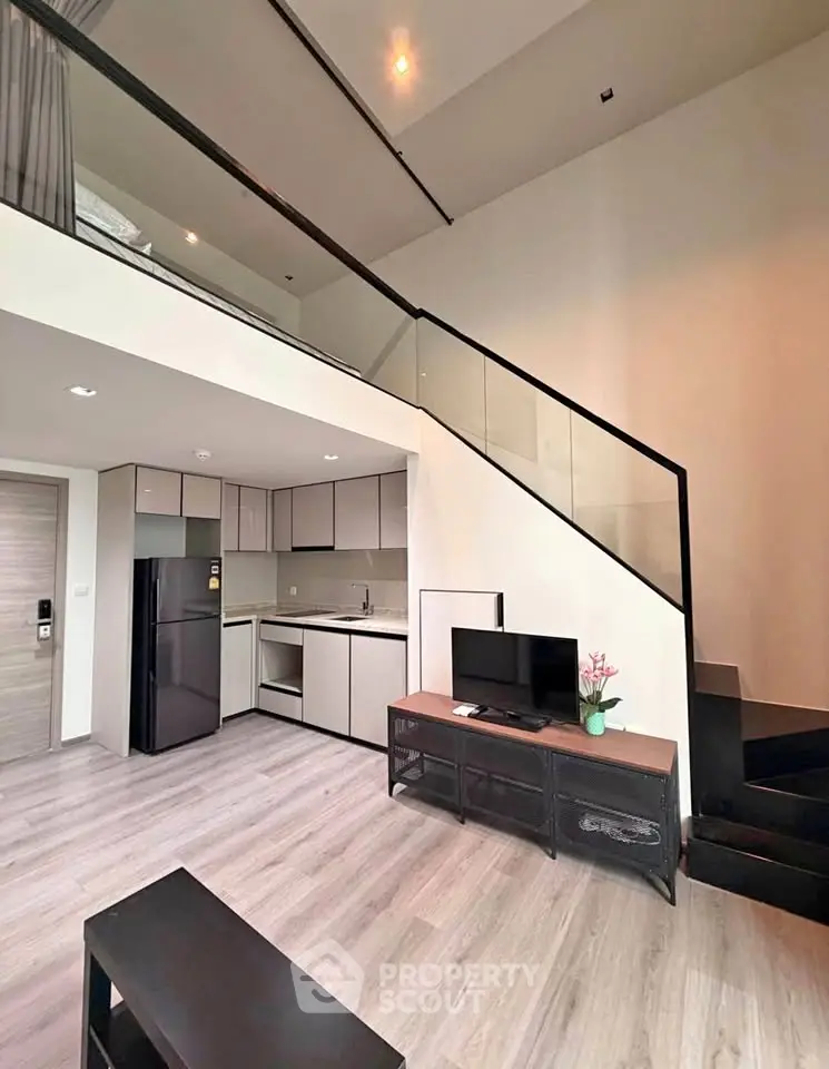 Modern loft apartment with sleek kitchen and stylish staircase