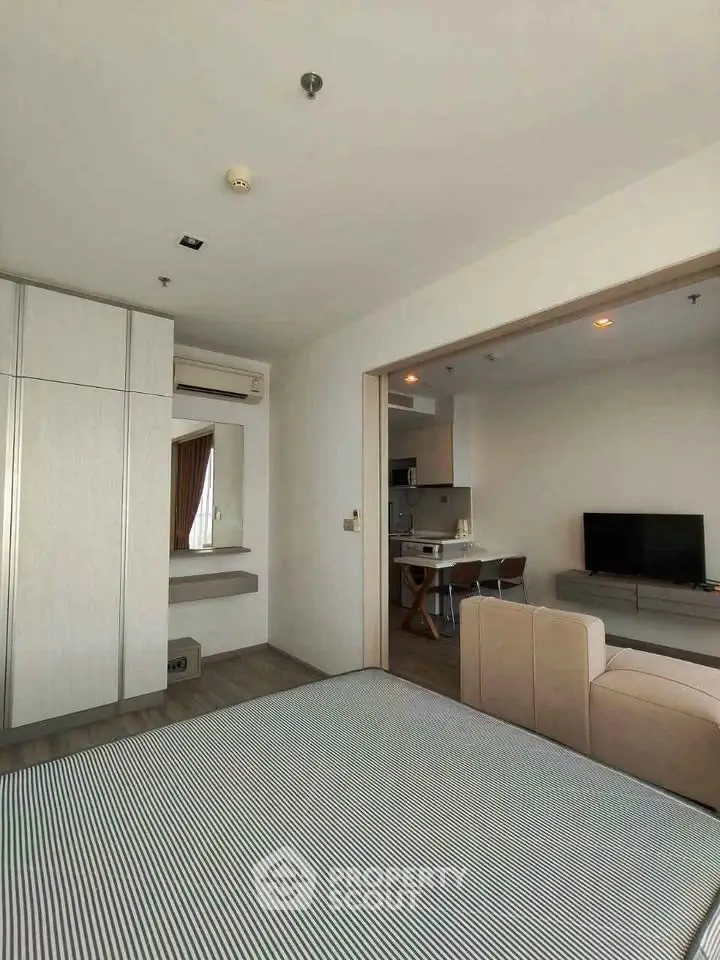 Modern open-plan living room with kitchen and stylish furniture in a contemporary apartment.