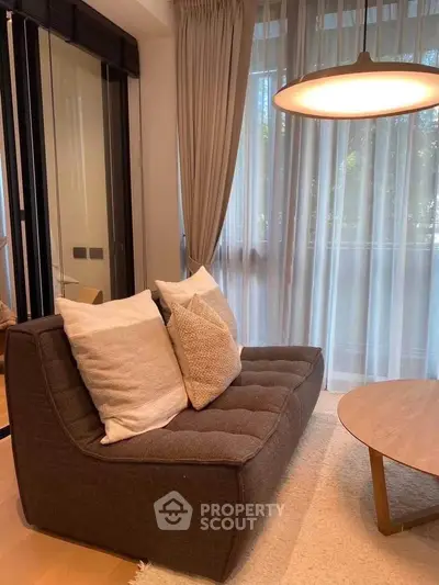 Cozy living room with modern sofa and elegant lighting, perfect for relaxation and comfort.