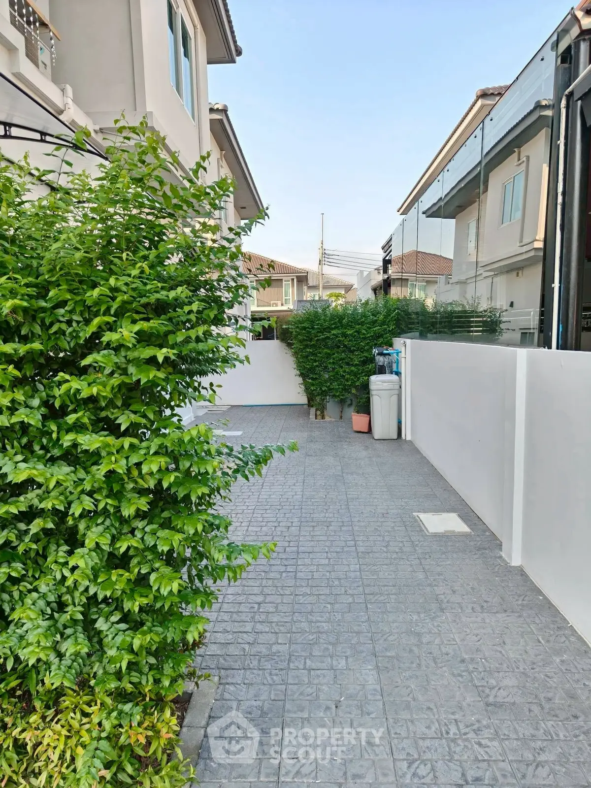 Charming residential exterior with lush greenery and modern design in a serene neighborhood.