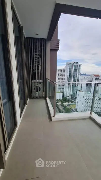 Spacious balcony with stunning city view in modern high-rise apartment