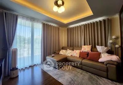 Cozy living room with elegant lighting and plush sofa, perfect for relaxation.