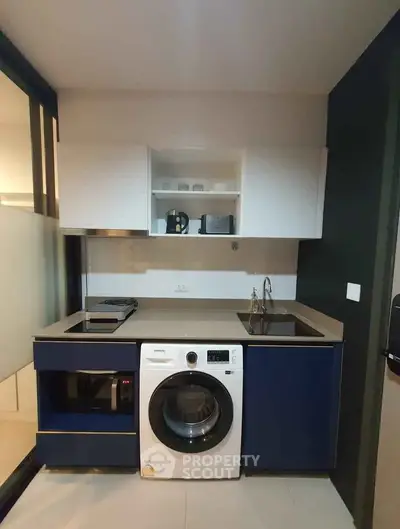 Modern compact kitchen with washing machine and sleek cabinetry