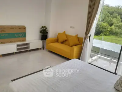 Modern bedroom with yellow sofa and balcony view