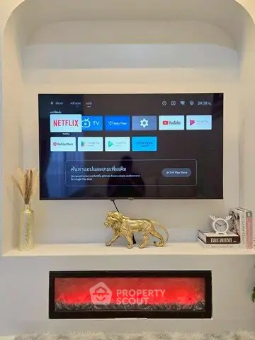 Modern living room with wall-mounted TV and decorative fireplace