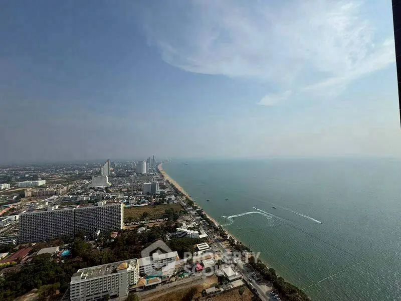 Stunning coastal cityscape with expansive ocean view from high-rise building.
