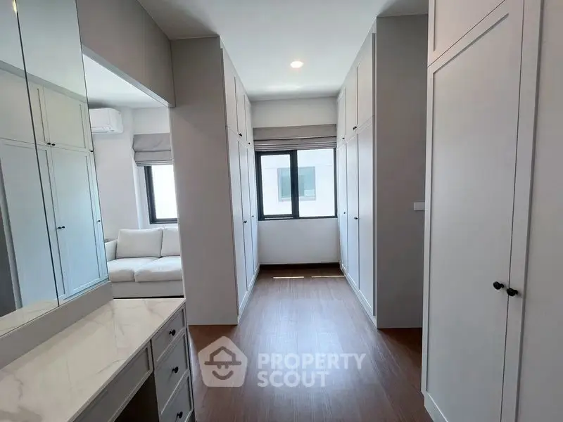 Spacious walk-in closet with ample storage and natural light