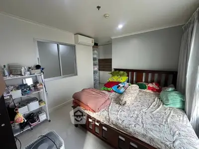 Cozy bedroom with natural light and organized storage space