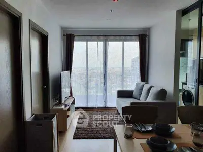 Modern living room with large window and cozy furniture