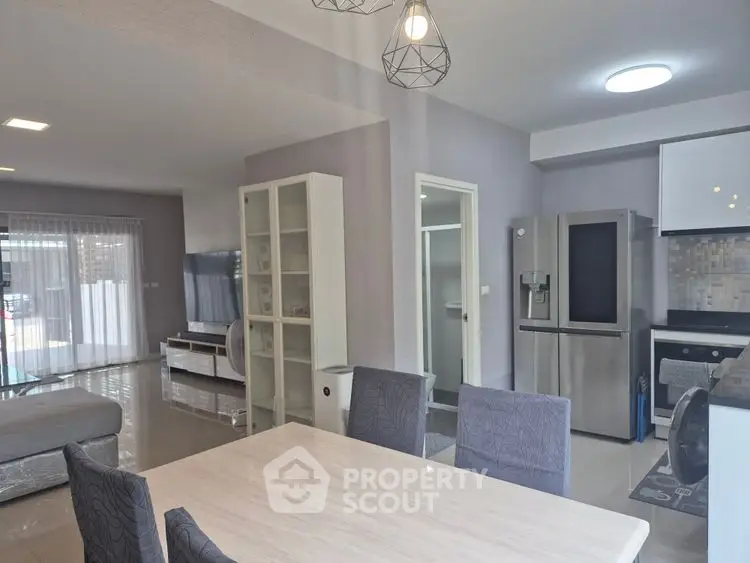 Spacious open-plan living and dining area with modern kitchen and stylish decor.