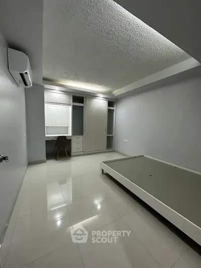 Spacious modern bedroom with built-in closet and sleek design
