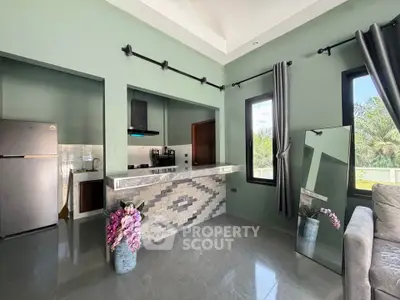 Modern kitchen with open layout, stylish backsplash, and large windows offering natural light.
