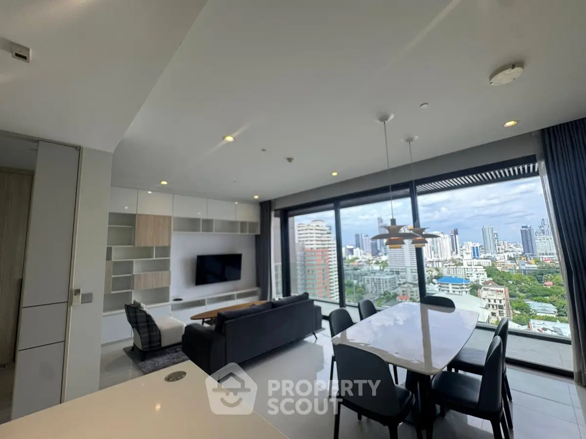 Modern living room with panoramic city view and elegant dining area