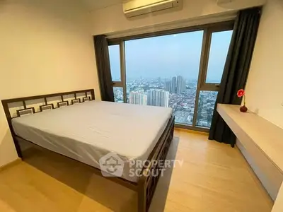 Spacious bedroom with stunning city view and modern furnishings