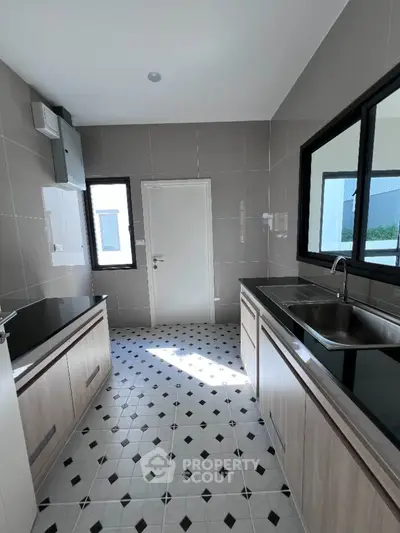 Modern kitchen with sleek cabinetry and stylish tiled flooring