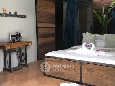 Charming rustic bedroom with vintage sewing machine and elegant decor, perfect for cozy living.
