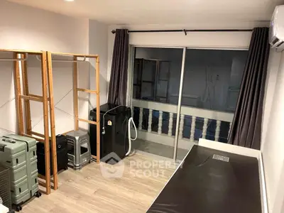 Compact bedroom with sliding glass doors and open closet space