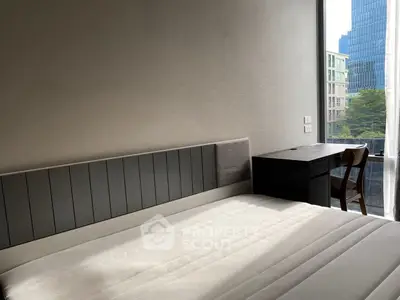 Modern bedroom with large window and city view, featuring a sleek bed and stylish desk.