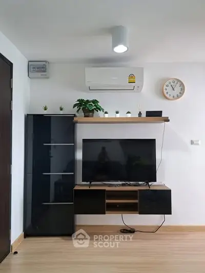 Modern living room with sleek TV setup and stylish shelving