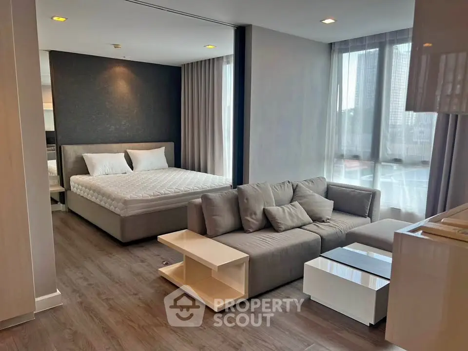 Modern studio apartment with stylish decor and large windows