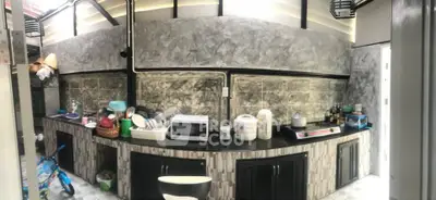 Spacious kitchen with modern appliances and stylish stone backsplash