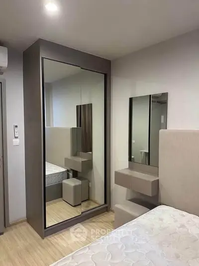 Modern bedroom with mirrored wardrobe and minimalist design