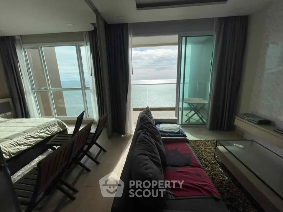 Luxurious beachfront living room with stunning ocean view and modern decor.