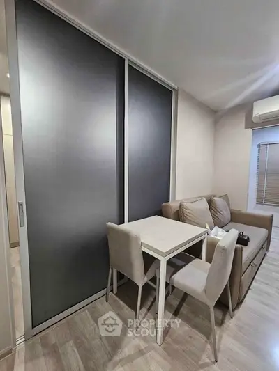 Modern living room with sleek sliding doors and cozy dining area