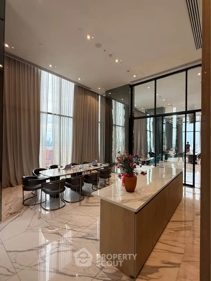 Luxurious dining area with marble flooring and floor-to-ceiling windows offering stunning city views.