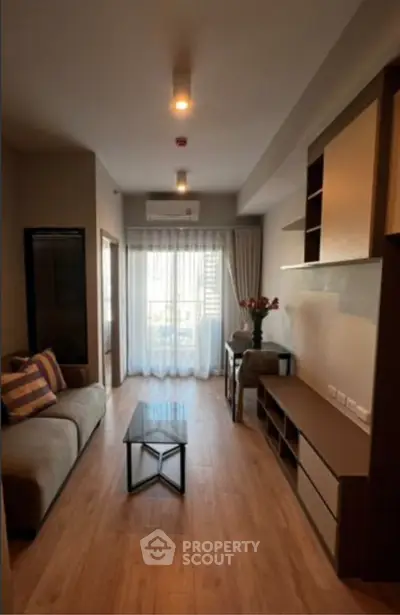 Modern living room with stylish furniture and natural light, perfect for cozy living.